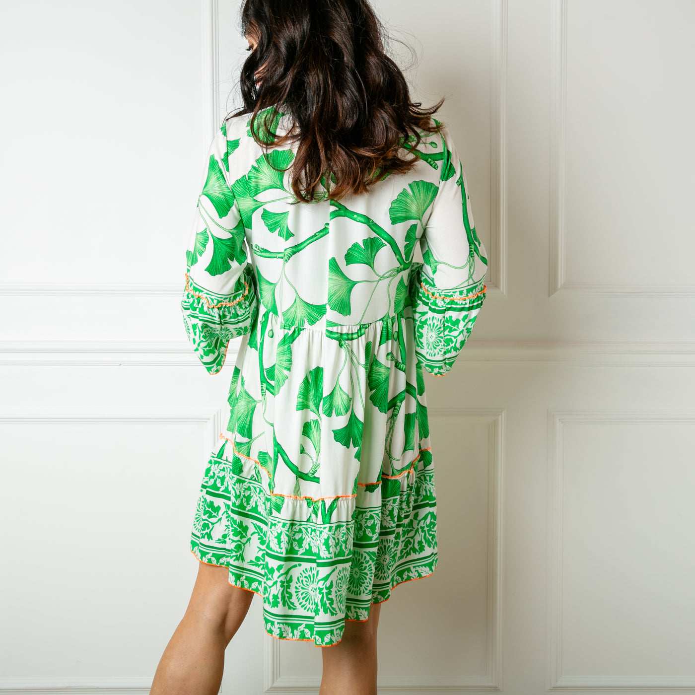 The green Florence Drawstring Dress which has a tiered skirt and falls just above the knee. Can be worn on its own or with trousers underneath for a tunic look